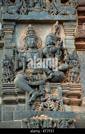 Sculpture of Lakshmi sitting in the lap of Lord Vishnu. Ranganayaki (Andal) temple situated in the North West to Chennakeshava temple. Belur, Karnatak Stock Photo
