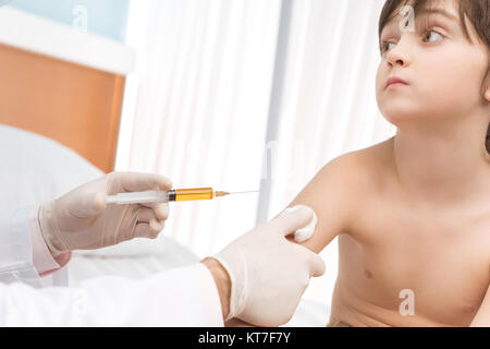 Cropped shot of doctor making injection to little boy in hospital Stock Photo