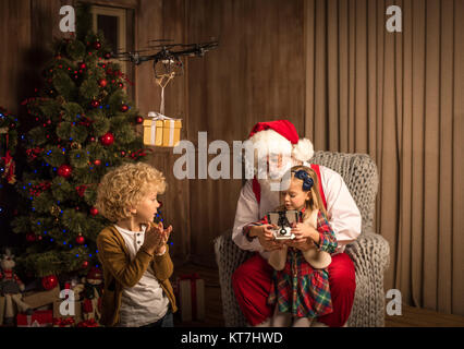 Santa Claus with children using hexacopter drone Stock Photo