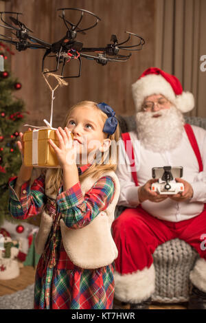 Santa with kid using hexacopter drone Stock Photo