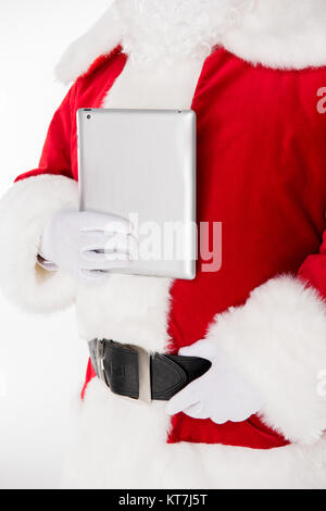 Santa Claus posing with digital tablet Stock Photo
