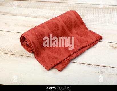 Rolled Red Towel on White Wood Stock Photo