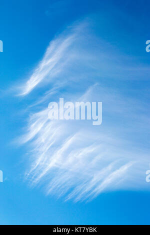Wispy cirrus clouds in blue sky Stock Photo
