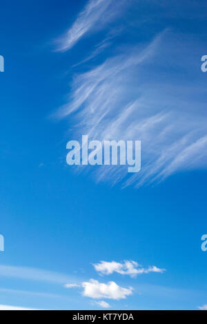 Cirrus over cumulus clouds in blue sky in the Canadian prairies Stock Photo