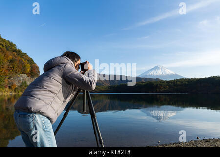 Woman taking photo on Mount Fuji Stock Photo