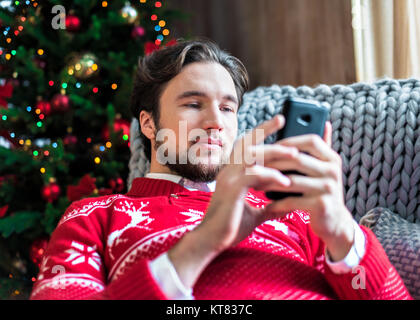 Smiling man using smartphone Stock Photo