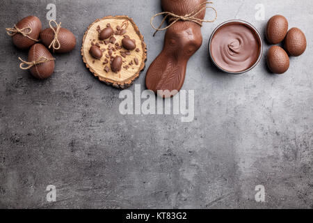 Chocolate Easter bunny and eggs on wooden background Stock Photo