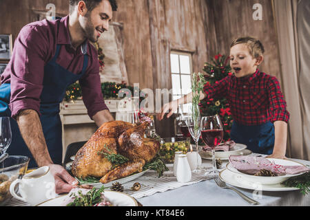 Father and son serving festive table Stock Photo