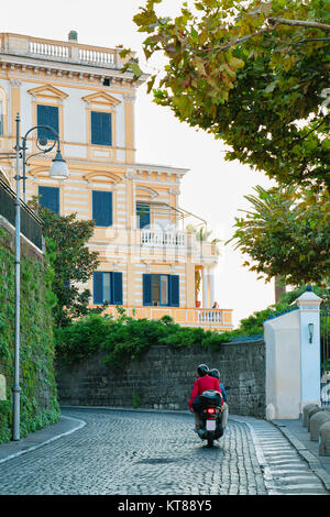 Tourists on motorcycle in the street at historical part of Sorrento, Amalfi coast, Italy Stock Photo
