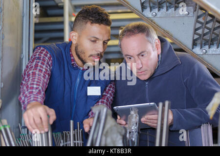 supplier with engineer checking on production in factory Stock Photo