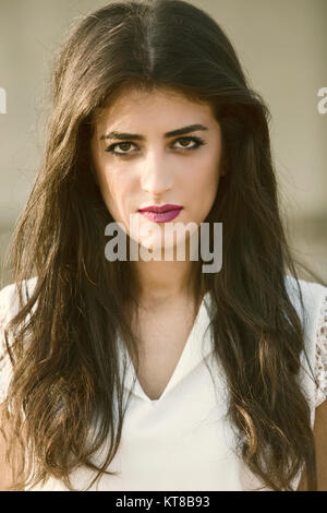 Serious young woman staring outdoors Stock Photo