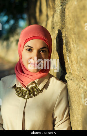 Beautiful Muslim woman standing outdoors Stock Photo