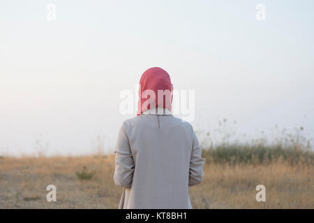 Rear view of Muslim woman wearing hijab standing outdoors Stock Photo ...