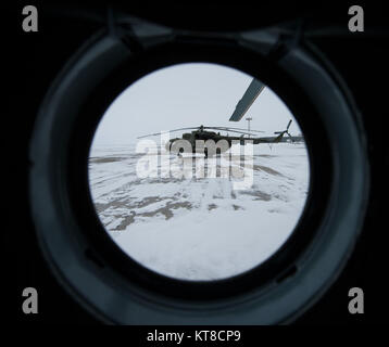 A Russian MI-8 helicopter is seen through the window of another helicopter at the Karanganda Airport shortly after poor weather forced the fleet of 12