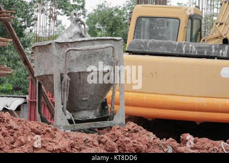 concrete bucket mixer container construction in building site workplace Stock Photo