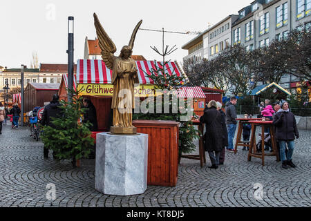 Berlin Spandau Angel & People enjoy typical Traditional German Christmas market stalls in cobbled Old Town Street Stock Photo