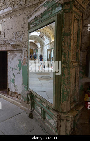 Large mirror in a cell wing allowing guards to see round corners inside the Eastern State Penitentiary Historic Site, Philadelphia, PA, United States. Stock Photo
