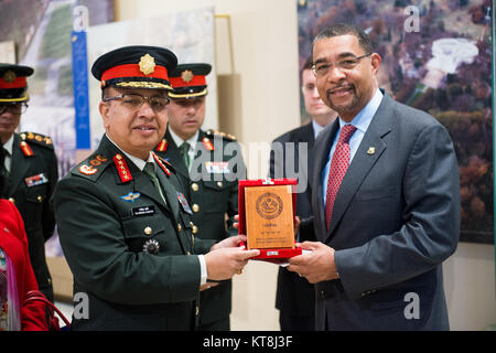 Gen. Rajendra Chhetri, left, chief of staff of the Nepalese Army, presents Brion Moore, right, deputy superintendent for cemetery operations with a gift to Arlington National Cemetery, April 29, 2016, in Arlington, Va. Chhetri also laid a wreath at the Tomb of the Unknown Soldier. (U.S. Army photo by Rachel Larue/Arlington National Cemetery/released) Stock Photo