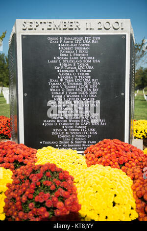 The Pentagon Group Burial Marker, located in Section 64 of Arlington National Cemetery, is the location of the 184 victims of the Sept. 11, 2001, attack on the Pentagon. It is a five sided granite group marker; on the five panels the names of the victims of all those that perished in the Pentagon or on American Airlines Flight 77 are listed alphabetically. (U.S. Army photo by Rachel Larue/Arlington National Cemetery/released) Stock Photo