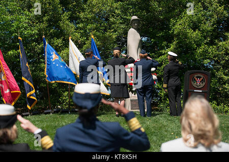 Col. Maggie Jones, deputy chief of nurses, Air Force, Col. Sandra McNaughton, senior nurse analyst, Defense Health Agency, Maj. Gen. Dorothy Hogg, deputy surgeon general and chief, Air Nurse Corps, and Capt. Deborah Roy, deputy chief of nurses, Navy, salute the Nurses Memorial during a wreath laying ceremony at Arlington National Cemetery in Virginia for National Nurses Week, May 8, 2017. Erected in 1938, the granite statue honors the nurses who served in the U.S. armed forces in World War I.  (U.S. Army photo by Elizabeth Fraser/Arlington National Cemetery/Released) Stock Photo