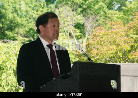 Michael Cardarelli, Japanese American Veterans Association, gives remarks during the Japanese American Citizens League and the JAVA’s annual Memorial Day Service in the Columbarium Courtyard at Arlington National Cemetery, May 24, 2015, in Arlington, Va. The service has been conducted for 67 years. (U.S. Army Photo by Rachel Larue/released) Stock Photo