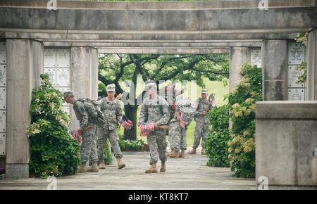 Soldiers from the 3d U.S. Infantry Regiment (The Old Guard), Charlie Company, enter the Columbarium in Arlington National Cemetery during “Flags in,” May 21, 2015, in Arlington, Va. During “Flags in” The Old Guard places 228,000 flags at every headstone. (U.S. Army photo by Rachel Larue/released) Stock Photo