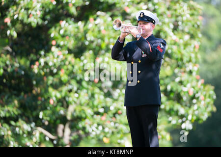 A bugler from The U.S. Navy Band participates in the graveside service of U.S. Navy Electronics Technician 1st Class Kevin Sayer Bushnell in Section 60 of Arlington National Cemetery, Arlington, Va., Oct. 5, 2017.  Bushnell perished when a collision occurred between the Arleigh Burke-class guided-missile destroyer John S. McCain and the Liberia-Flagged merchant vessel Alnic MC, Aug. 21, 2017. Bushnell went missing with 9 other sailors in the waters east of the Straits of Malacca and Singapore. His remains were recovered after the U.S. Navy and Marine Corps divers searched the surrounding water Stock Photo