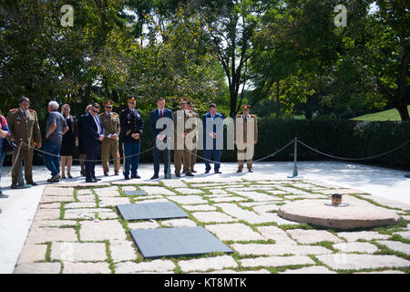 Maj. Karl Sondermann, deputy director of events and ceremonies, Arlington National Cemetery (center), escorts His Excellency Mihai Fifor, Romanian Minister of National Defence, at the John F. Kennedy Gravesite at Arlington National Cemetery, Arlington, Va., Sept. 19, 2017.  Fifor participated in an Armed Forces Full Honors Wreath-Laying Ceremony earlier at the Tomb of the Unknown Soldier. (U.S. Army photo by Elizabeth Fraser / Arlington National Cemetery / released) Stock Photo