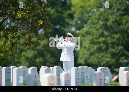 MU1 William Dunn, a bugler from the U.S. Navy Band, plays taps during the graveside service of U.S. Navy Petty Officer 1st Class Xavier A. Martin at Arlington National Cemetery, Arlington, Va., Aug. 9, 2017. Martin perished when the USS Fitzgerald (DDG 62) was involved in a collision with the Philippine-flagged merchant vessel ACX Crystal, flooding the berthing compartment he was occupying. Martin was buried with standard honors in Section 60. (U.S. Army photo by Elizabeth Fraser / Arlington National Cemetery / released) Stock Photo