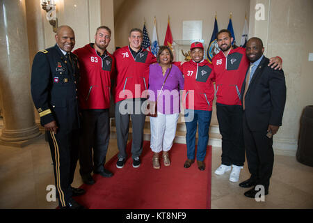 Members of the Atlanta Falcons front office lay a wreath at the