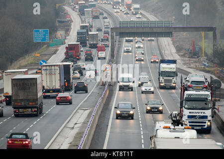 Busy traffic along the M6 Motorway with all three lanes in both directions full of traffic near to the Sandbach junction, Cheshire, UK Stock Photo