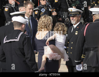 San Diego, California, USA. 23rd Dec, 2017. Wife ASHLEY IVERSON and daughter Evie are escorted by CAL FIRE at the celebration of life of Cory Iverson who was killed battling the Thomas Fire at the Rock Church in San Diego on Saturday December 23, 2017. Credit: Kevin Warn/ZUMA Wire/Alamy Live News Stock Photo