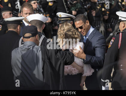 San Diego, California, USA. 23rd Dec, 2017. Wife Ashley Iverson and daughter Evie are escorted by CAL FIRE at the celebration of life of Cory Iverson who was killed battling the Thomas Fire at the Rock Church in San Diego on Saturday December 23, 2017. Credit: Kevin Warn/ZUMA Wire/Alamy Live News Stock Photo