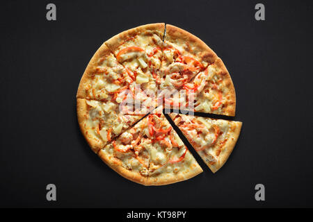 hawaiian pizza isolated on black stone background Stock Photo