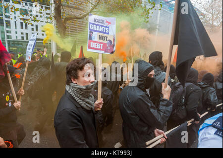 The autonomous bloc on the student march let off flares and threw objects at the police guarding the Home Office. They called for an end to the UK's racist immigration policies aned shameful treatment of refugees and asylum seekers. Stock Photo