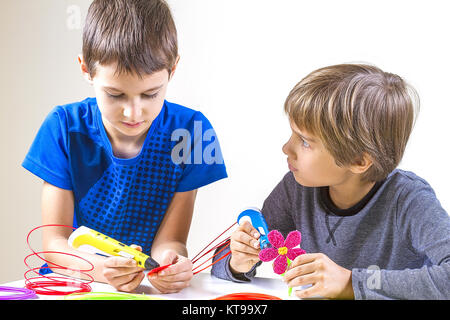 Happy children creating with 3d printing pen Stock Photo - Alamy