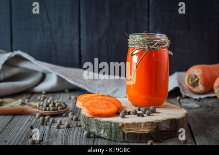 Glass jar with juice on a wooden surface Stock Photo