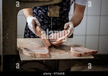 Butcher is cutting beef meat
