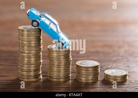 Car Model Over A Stacked Coin Stock Photo