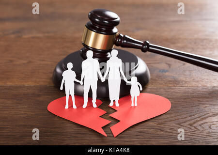 Family Paper Cut On Broken Heart With A Gavel Stock Photo