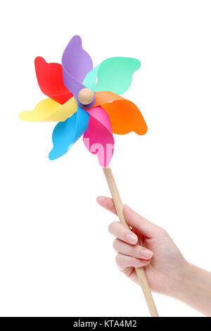 Hand holding colorful toy pinwheel on white background Stock Photo