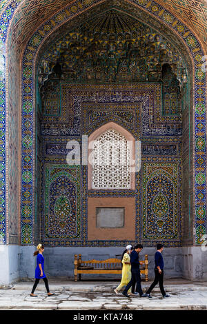 Young Uzbek Visitors Inside The Sher Dor Madrassa, The Registan, Samarkand, Uzbekistan Stock Photo