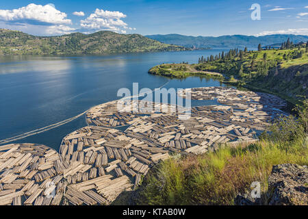 Log Booms on Okanagan Lake with Kelowna British Columbia Canada in the Background on a summer day Stock Photo