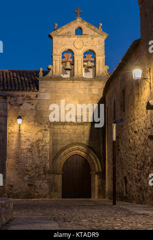 Evening View of the Gothic styled Walls, Arched Entrance and Bell Tower of the Convento de San Pablo, Caceres, Spain Stock Photo