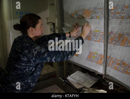 PORTLAND, Ore. (Dec 13, 2017) – Engineman 3rd class Brittany Randall, from Louisville, Ky., assigned to the submarine tender USS Frank Cable (AS 40), practices her damage control plotting skills to prepare to train her shipmates, Dec. 13. Frank Cable is currently completing a dry-dock phase maintenance availability. The ship will get underway soon for sea trials, which constitutes the final determination of a ship’s ability to re-join the fleet as an operational unit to conduct maintenance and support submarines and surface vessels deployed to the Indo-Asia-Pacific region. (U.S. Navy Stock Photo