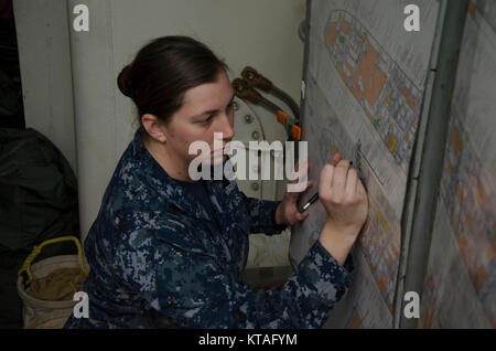 PORTLAND, Ore. (Dec 13, 2017) – Engineman 3rd class Brittany Randall, from Louisville, Ky., assigned to the submarine tender USS Frank Cable (AS 40), practices her damage control plotting skills to prepare to train her shipmates, Dec. 13. Frank Cable is currently completing a dry-dock phase maintenance availability. The ship will get underway soon for sea trials, which constitutes the final determination of a ship’s ability to re-join the fleet as an operational unit to conduct maintenance and support submarines and surface vessels deployed to the Indo-Asia-Pacific region. (U.S. Navy Stock Photo