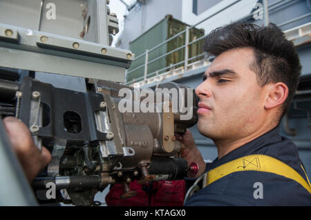 INDIAN OCEAN (Dec. 20, 2017) Gunner’s Mate 2nd Class Lester Carrillo, a Los Angeles native, assigned to the weapons department aboard the amphibious assault ship USS America (LHA 6), removes the receiver on a Mark 38 Mod. II machine gun system in preparation for a live fire exercise. America, part of the America Amphibious Ready Group, with embarked 15th Marine Expeditionary Unit, is operating in the Indo-Asia Pacific region to strengthen partnerships and serve as a ready-response force for any type of contingency. (U.S. Navy Stock Photo