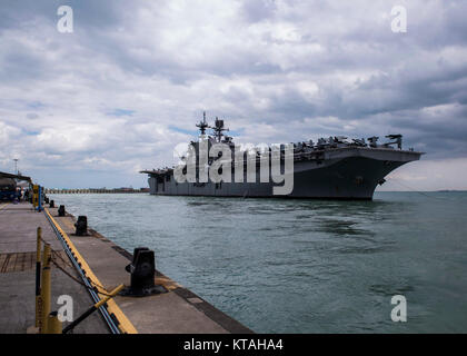 Singapore (Dec. 22, 2017) - The amphibious assault ship USS America (LHA 6) pulls in to RSS Singapura - Changi Naval Base, Singapore during a regularly scheduled port visit Dec. 22. America, part of the America Amphibious Ready Group, with embarked 15th Marine Expeditionary Unit, is operating in the Indo-Asia Pacific region to strengthen partnerships and serve as a ready-response force for any type of contingency. (U.S. Navy Stock Photo