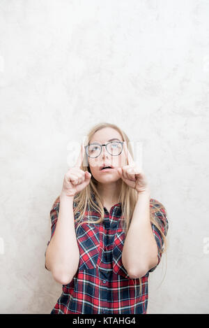 Deep sight of the attractive blonde head woman wearing glasses looking up indoor Stock Photo