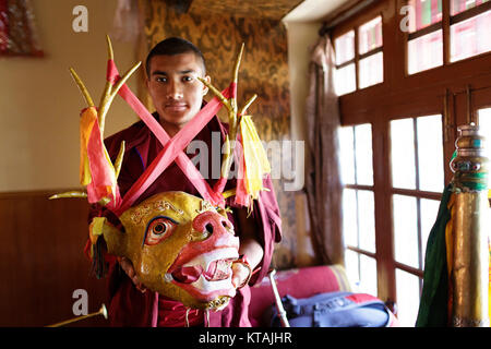 Monk from Yellow hat school showing the mask while preparing for the annual celebration in Diskit Monastery, Ladakh, Jammu and Kashmir, India. Stock Photo